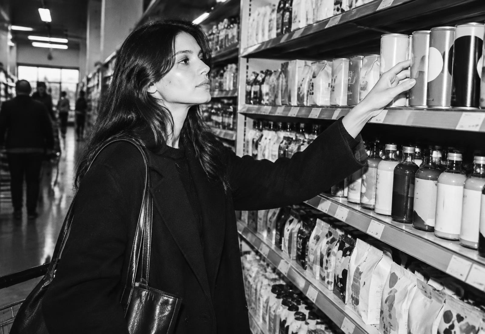 A shopper reaches for a product on a retail shelf